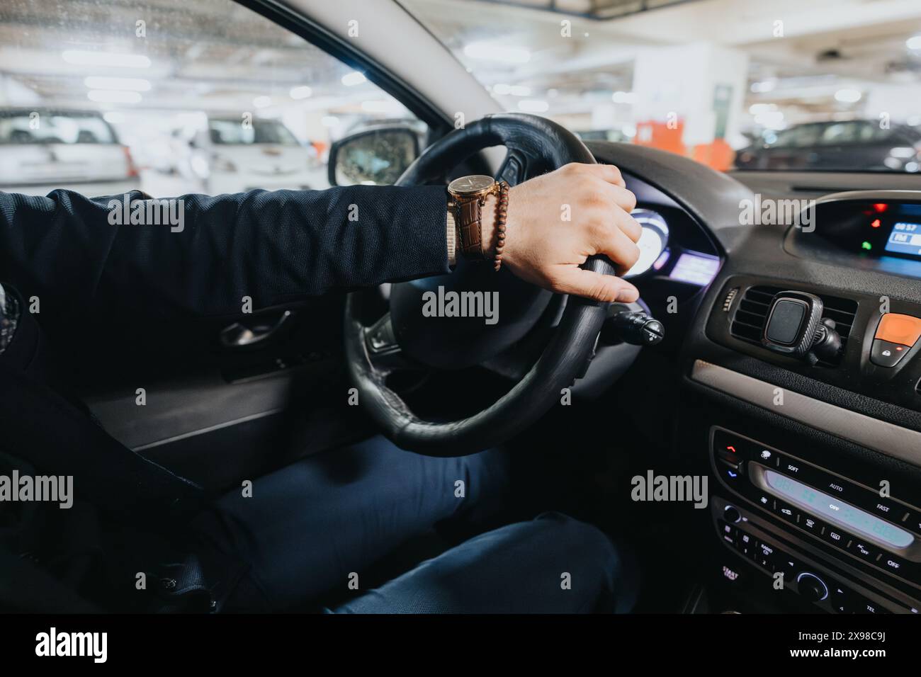 Close up of male hand starting car engine with modern key fob Stock Photo