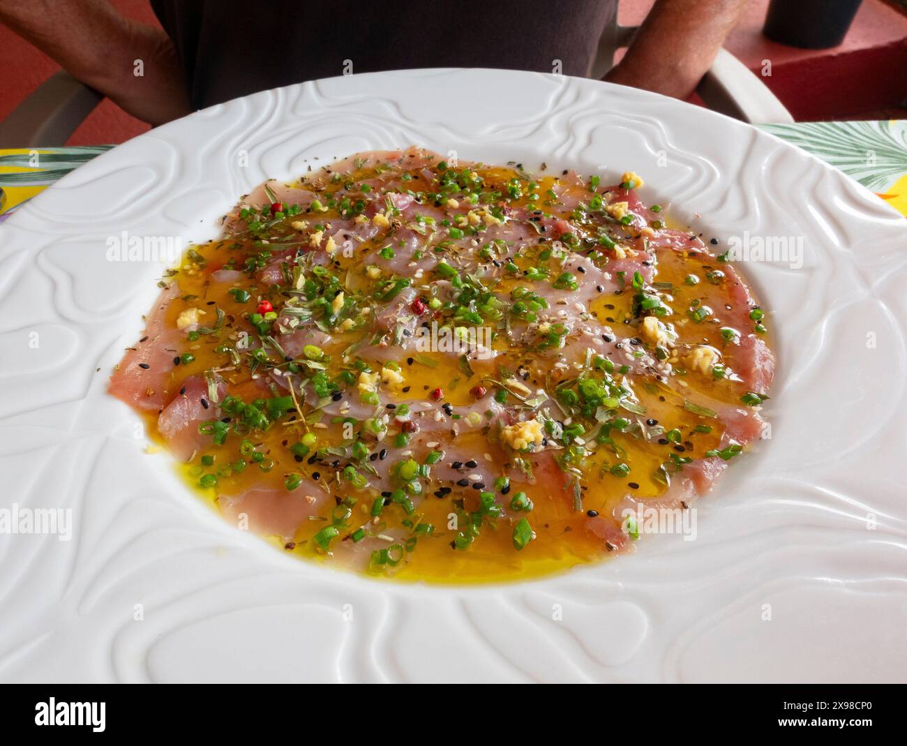 Carpaccio of red tuna served on a white plate, a typical dish from French Polynesia Stock Photo