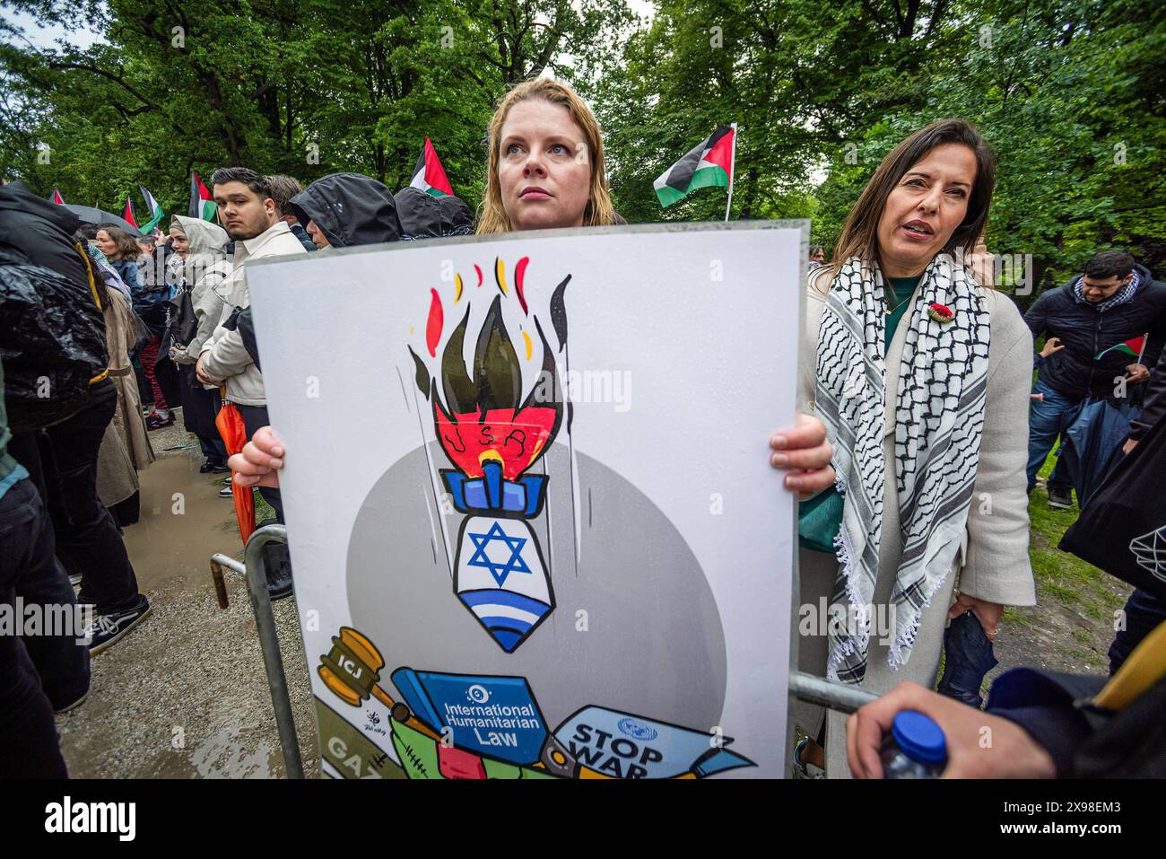 Pro-Palestinian female supporters holding a poster and expressing her opinion, during today's 'Hands of Rafah' demonstration in The Hague. A few hundred pro-Palestinian protesters stood opposite the 'Tweede Karmer' or, the 'Second Chamber' the Dutch seat of government in The Hague, during todayís 'Hands off Rafah - Where is your red line Rutte?'. The demonstrators stood in pouring rain, some with megaphones, and demanding the Dutch government change its stance in its support of Israel. The demonstration was in response to Rafah on Sunday, in which 45 people were killed, according to the Humas- Stock Photo