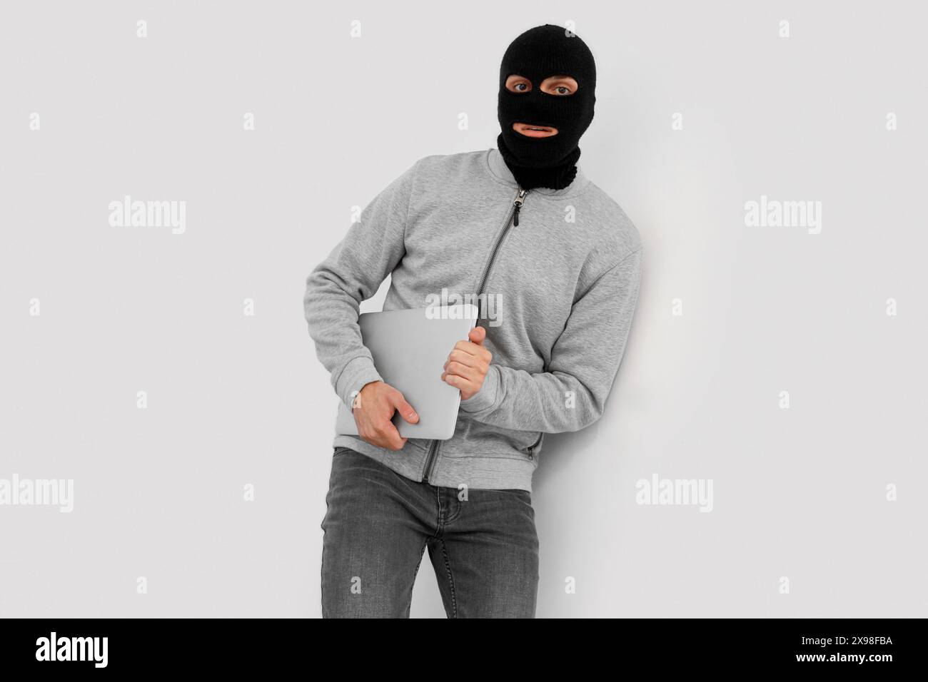 Male thief with laptop escaping in stairway Stock Photo - Alamy