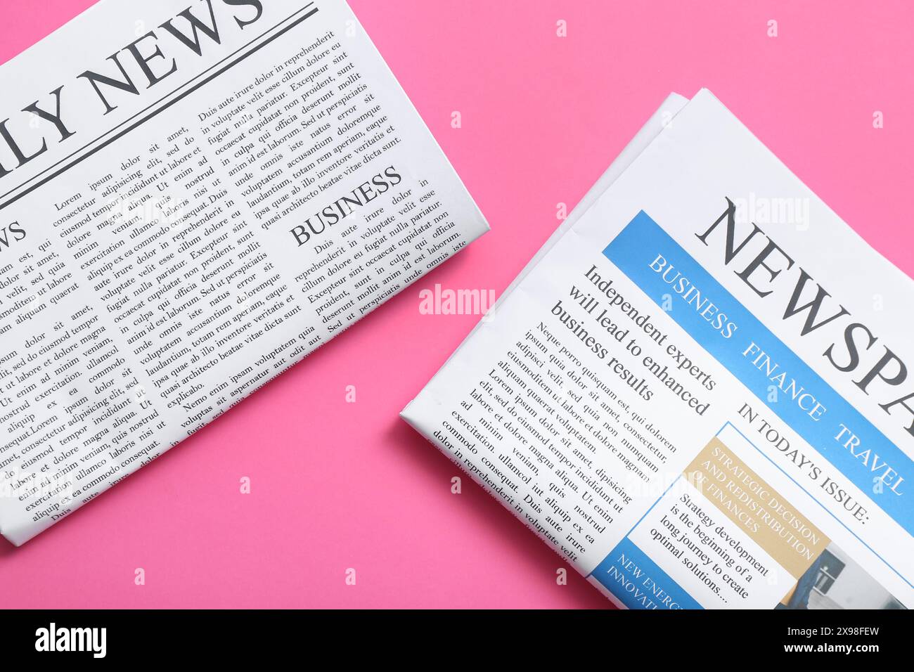 Different newspapers on pink background Stock Photo