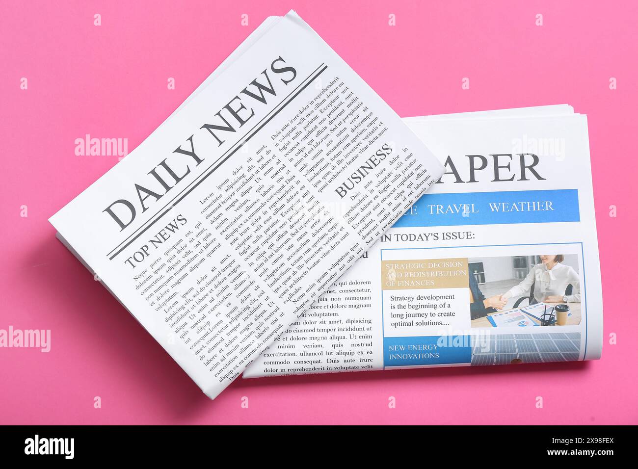 Different newspapers on pink background Stock Photo