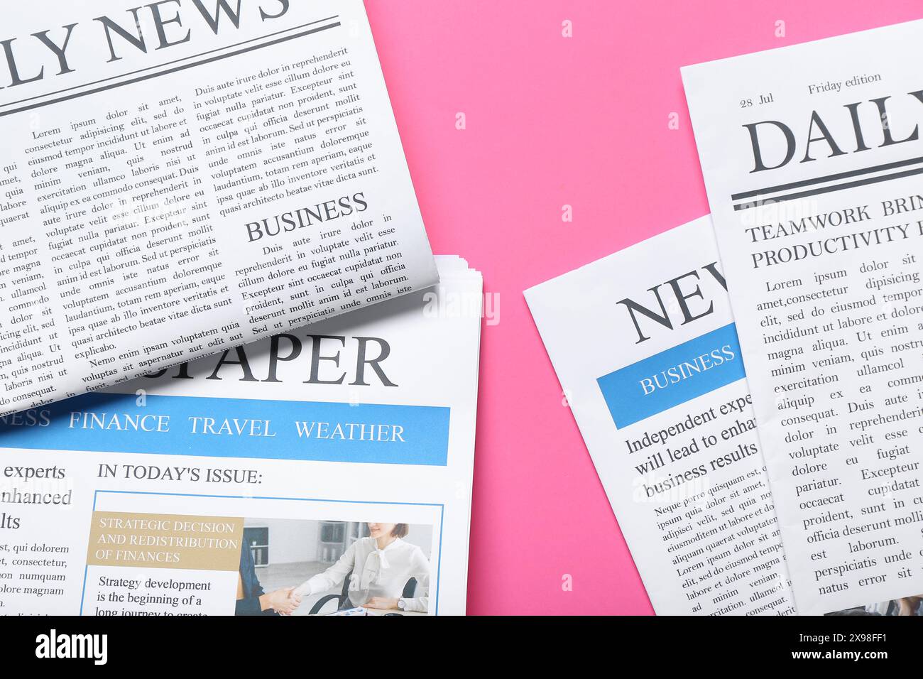 Different newspapers on pink background Stock Photo