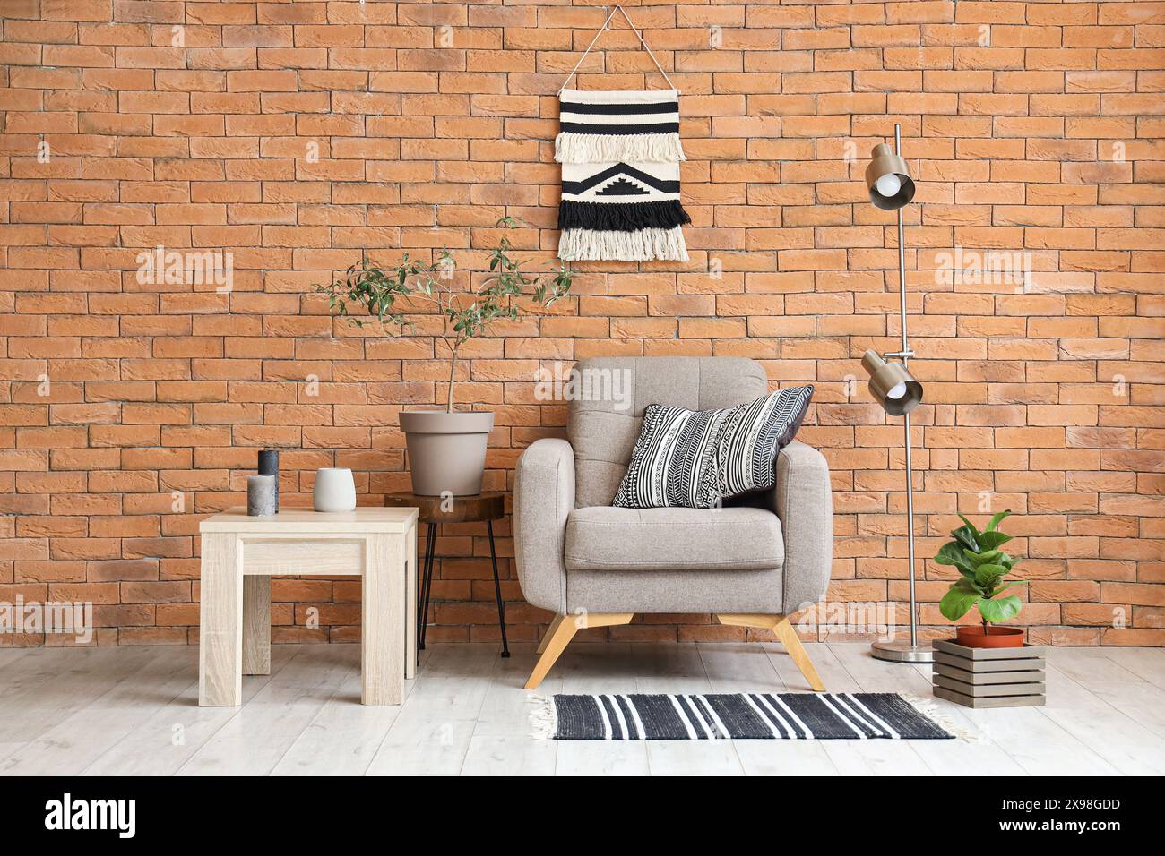 Interior of living room with grey armchair, lamp and table Stock Photo ...