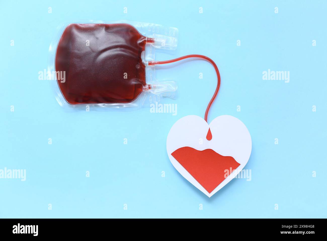 Blood pack with paper heart on blue background. World Blood Donor Day ...
