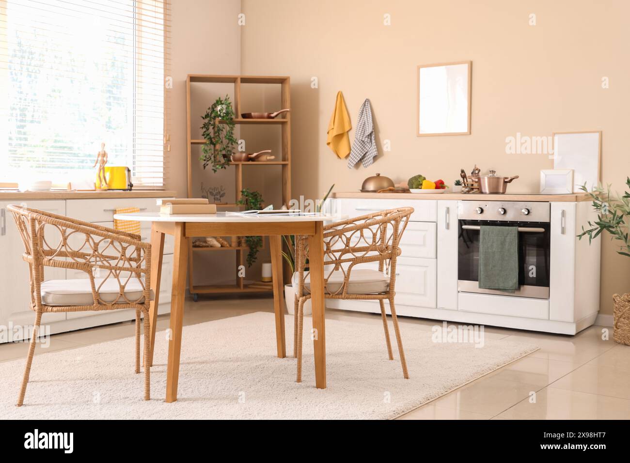 Interior of modern kitchen with dining table, white counters and blank ...