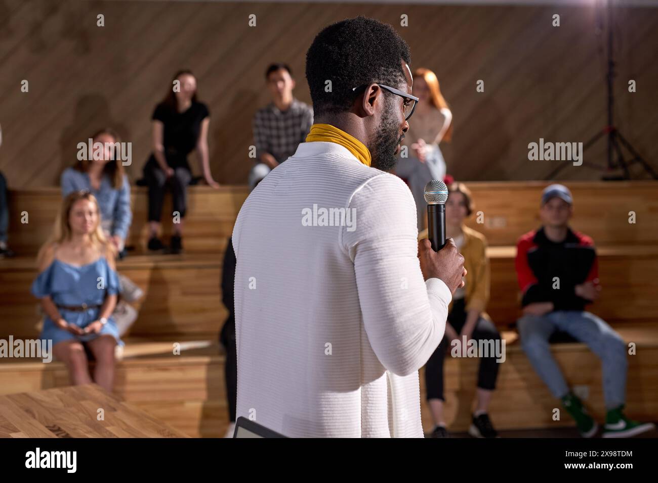 Successful lecturer presenting lesson with microphone to caucasian ...