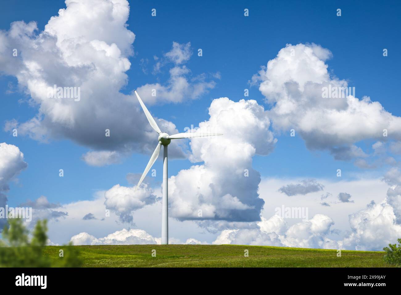 Wind Turbine on a Hill with Blue Sky and Clouds Stock Photo - Alamy