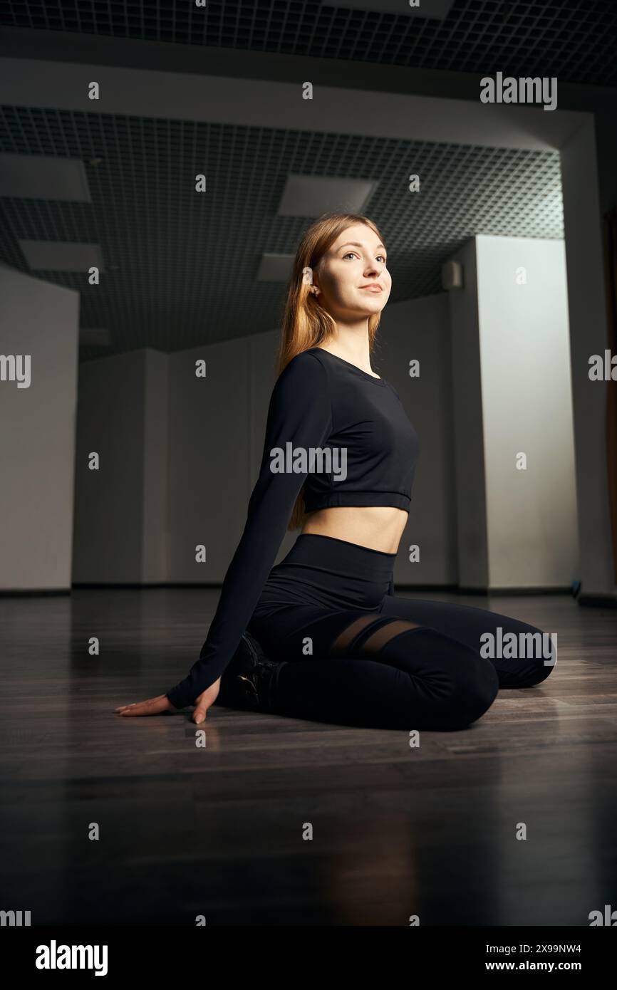 Young female dancer is doing floorwork choreography Stock Photo