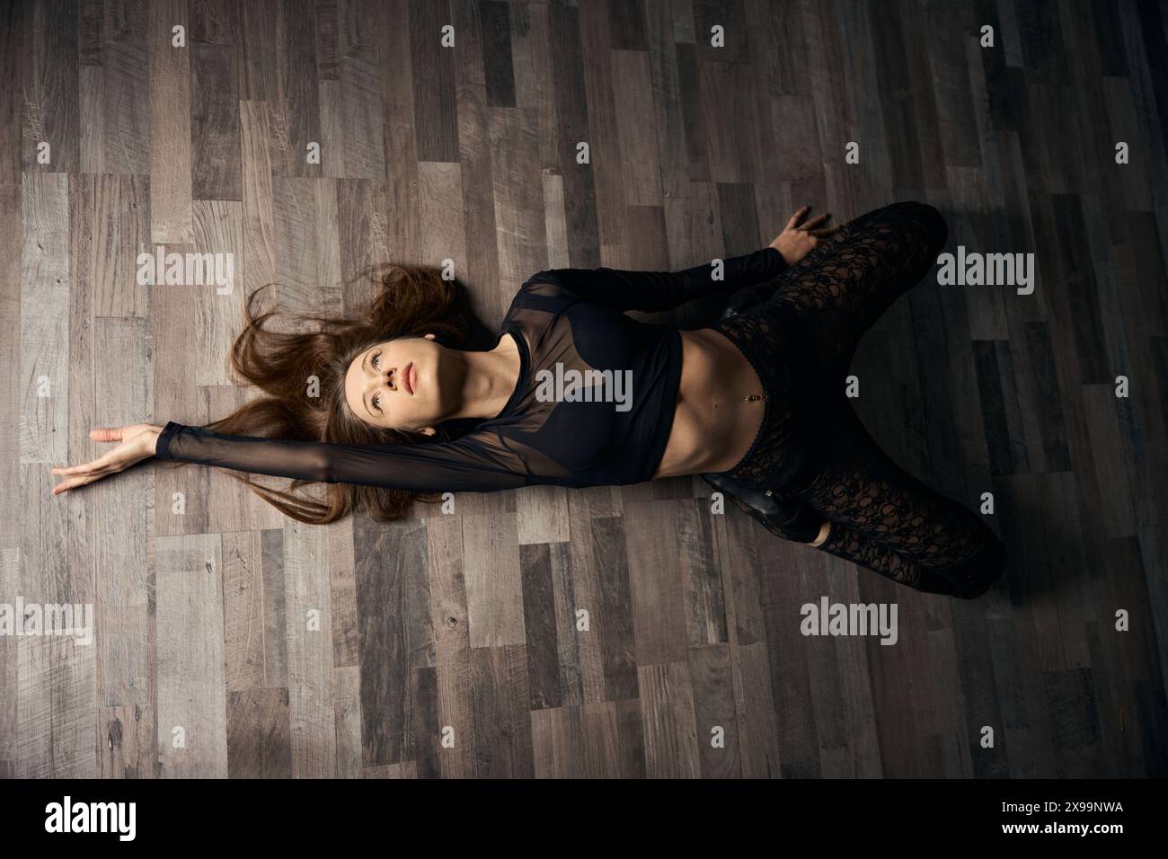 Female dancer practicing floorwork moves in high heels Stock Photo