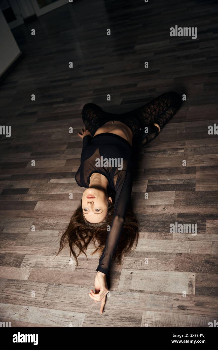 Stiletto dancer is doing floorwork choreography in dance studio Stock Photo