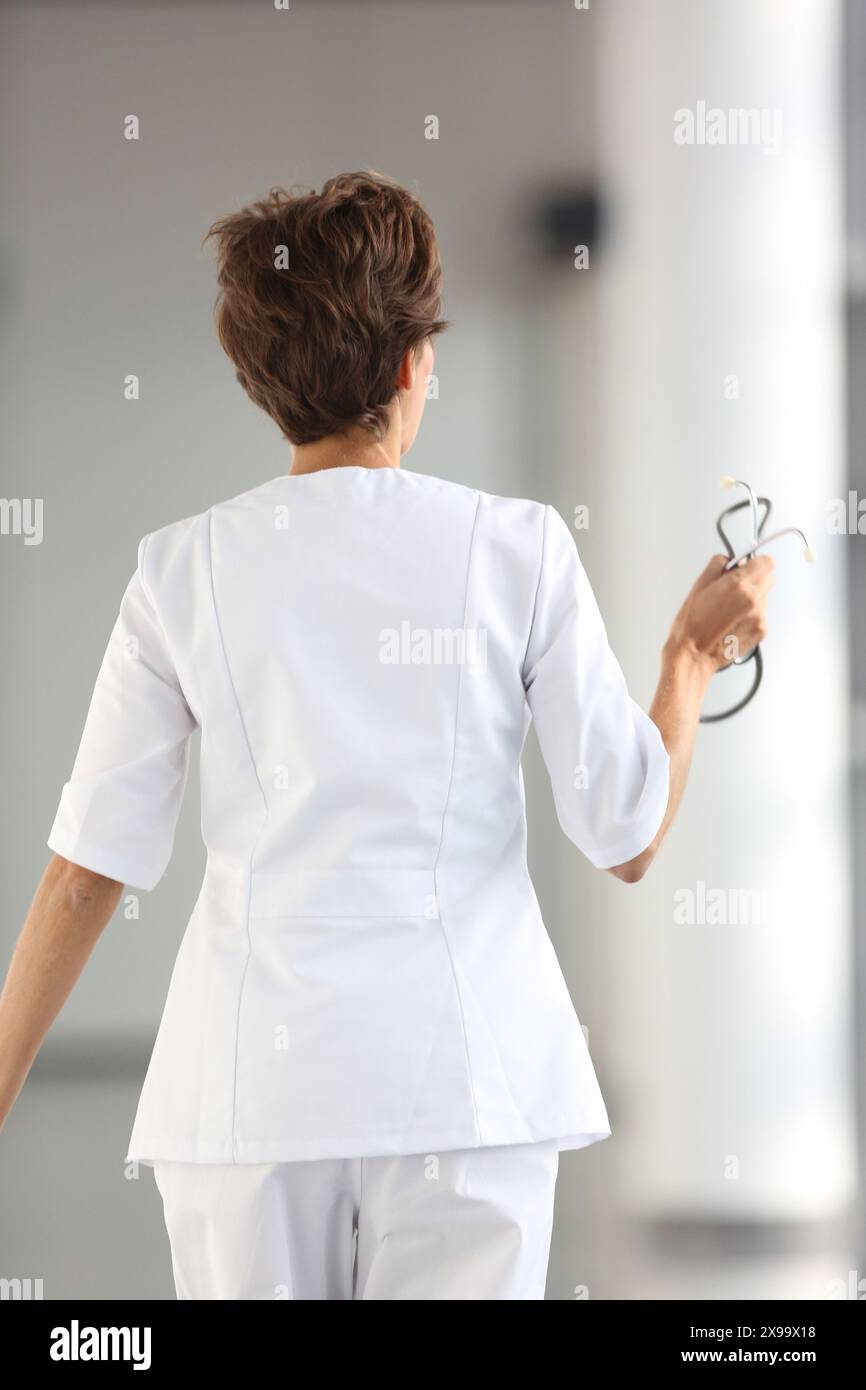 Nurse walking corridor back hi-res stock photography and images - Alamy