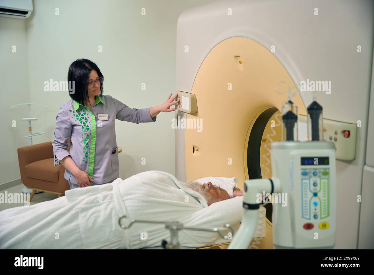 Doctor sends old patient to MRI machine Stock Photo - Alamy