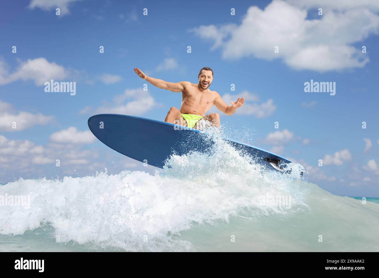 Male surfer riding a surfboard on a wave in the ocean Stock Photo - Alamy