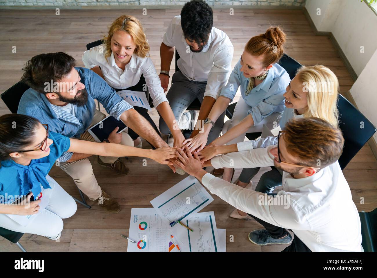 Group of multiethnic business people brainstorming, analyzing financial reports in office Stock Photo