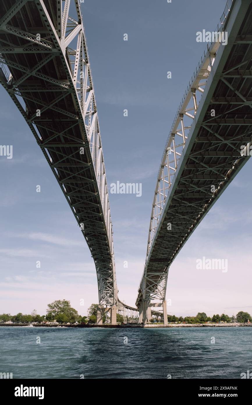 The Blue Water Bridge spans the St. Clair River, linking Port Huron Michigan USA and Sarnia Ontario Canada. Stock Photo