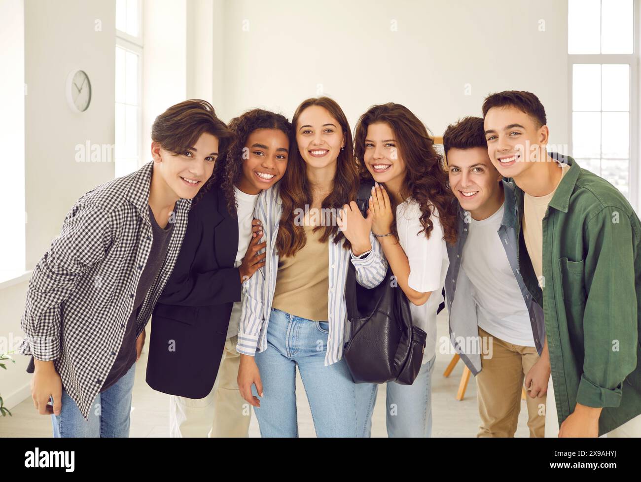 Group portrait of happy diverse high school boys and girls standing in ...
