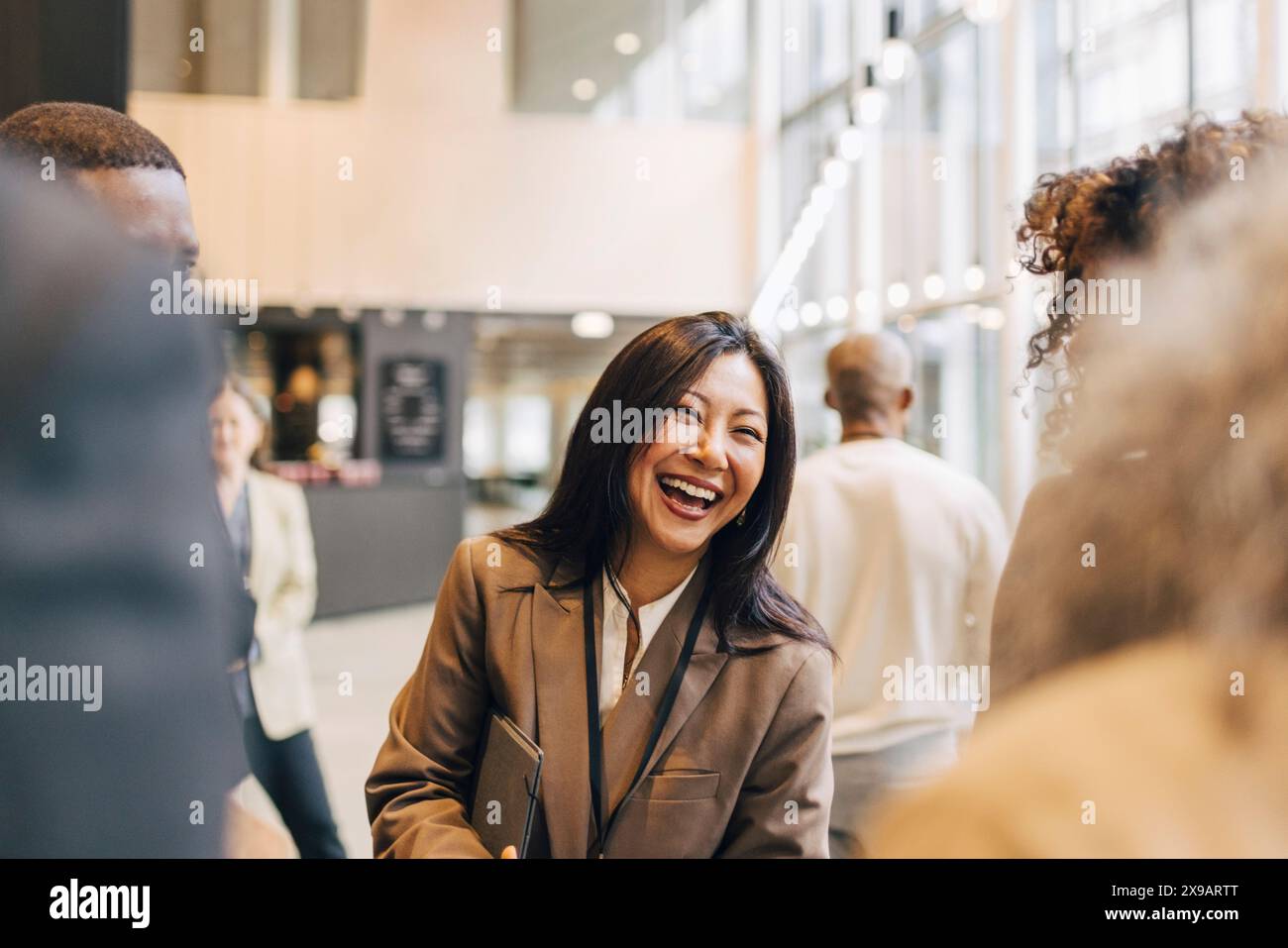 laughing-female-entrepreneur-discussing-with-delegates-during