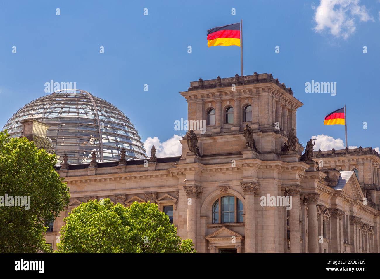 View of the glass dome and waving German national flags on the ...