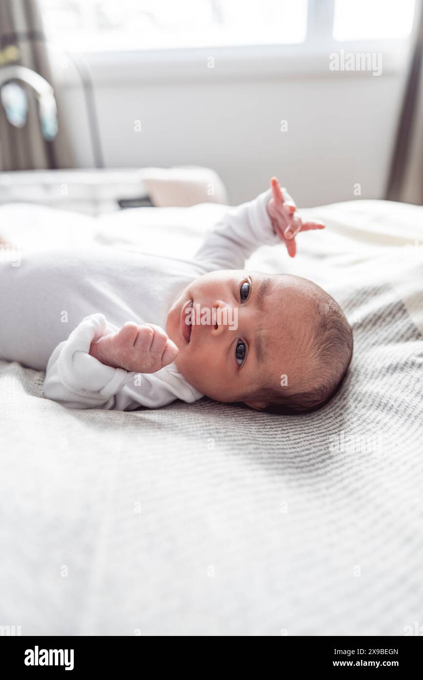 black newborn baby lay on bed at home Stock Photo Alamy