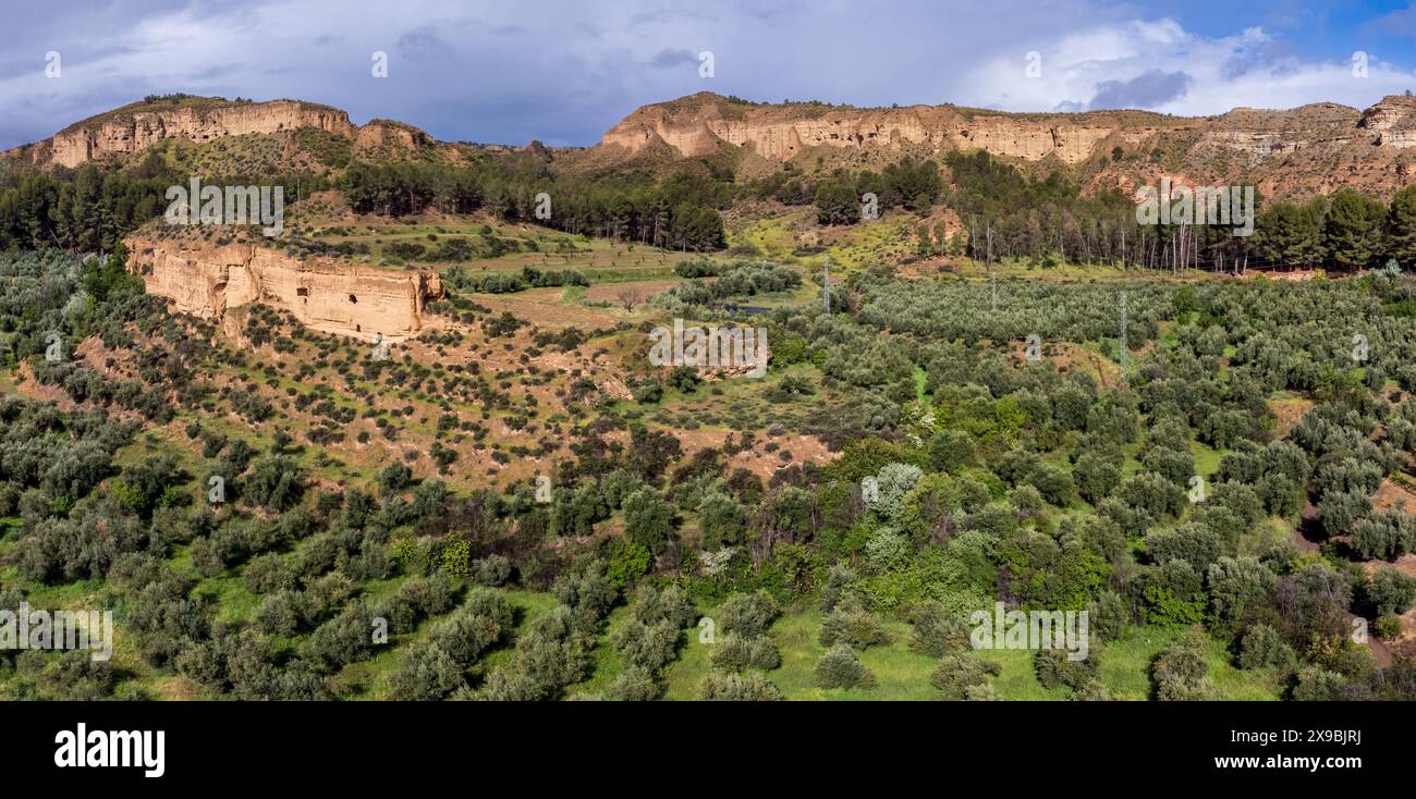 troglodyte granaries in the rock walls of Lares, Granada Geopark, Granada province, Andalusia, Spain Stock Photo