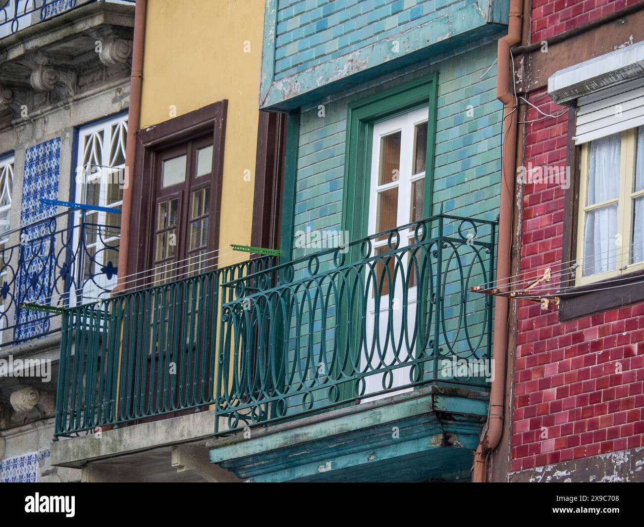 Facades of houses with colourful balconies, clotheslines and windows
