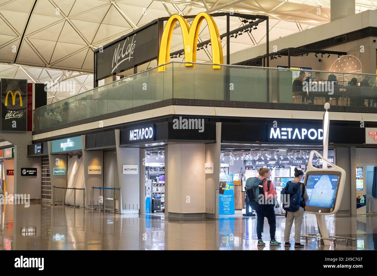 Hong Kong, China. 4th May, 2024. Flight passengers stand near a large