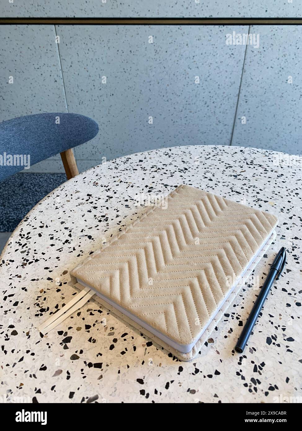 Beige notebook and pen on a table in cafe Stock Photo