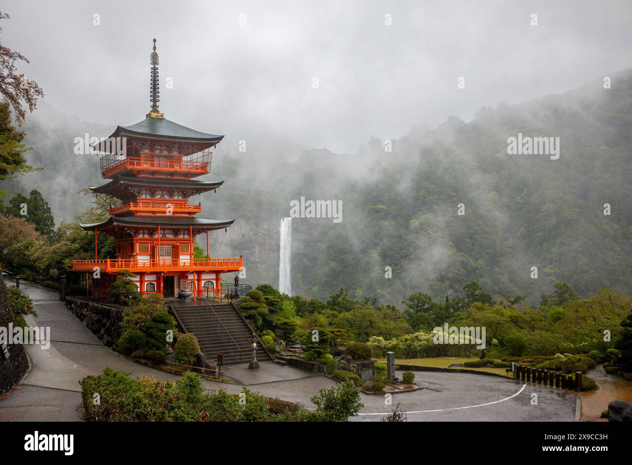 Seiganto-ji Temple Pagoda with Nachi Falls behind on Kumano Kodo hiking trail, April, Japan Stock Photo