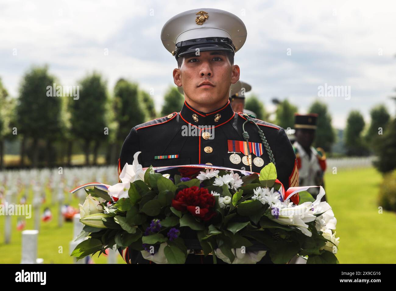 Aisne, France. 26th May, 2024. U.S. Marine Corps Sgt. Ryan Leblanc, a squad leader with 1st Battalion, 6th Marine Regiment, 2d Marine Division, holds a wreath during a ceremony at the Aisne-Marne American Cemetery, Belleau, France, May 26, 2024. The memorial ceremony was held in commemoration of the 106th anniversary of the battle of Belleau Wood, conducted to honor the legacy of service members who gave their lives in defense of the USA and European allies. (Credit Image: © U.S. Marines/ZUMA Press Wire) EDITORIAL USAGE ONLY! Not for Commercial USAGE! Stock Photo