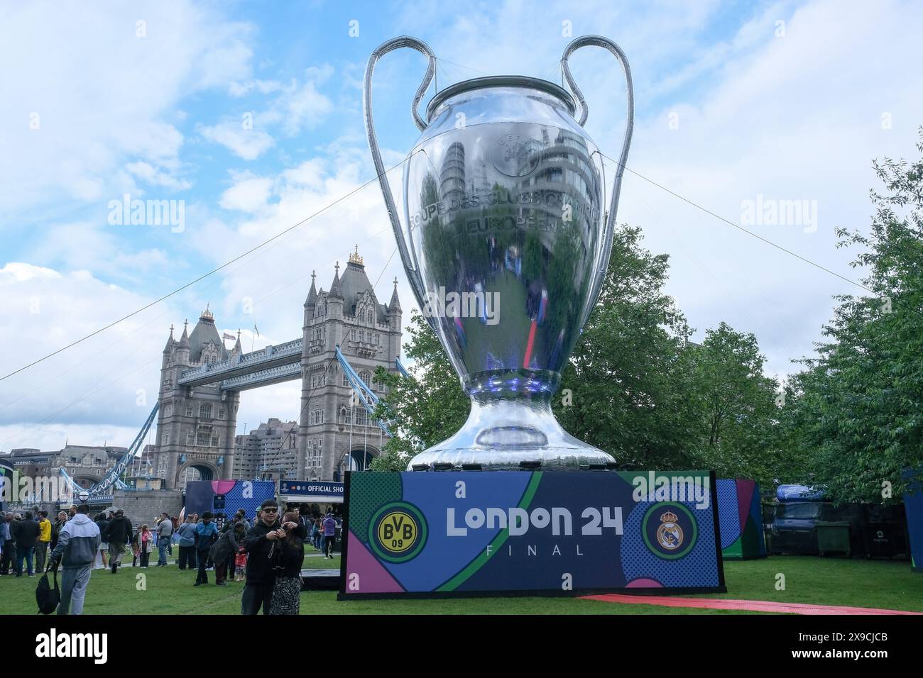 London, UK. The Potters Fields Champions Festival fanzone with a giant trophy and Tower Bridge seen in the background. Stock Photo