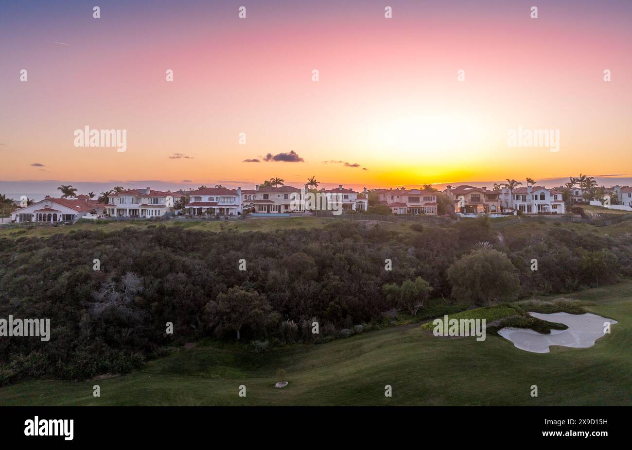 Aerial view of real estate development, luxury villas, single family homes in California near the Pacific Ocean over a gulf course Stock Photo