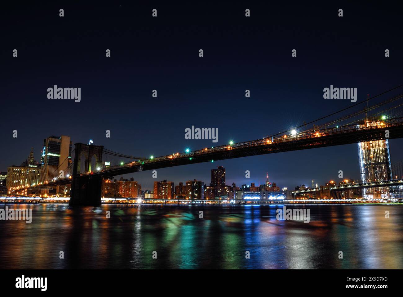 Night View of the Illuminated Brooklyn Bridge over the East River ...