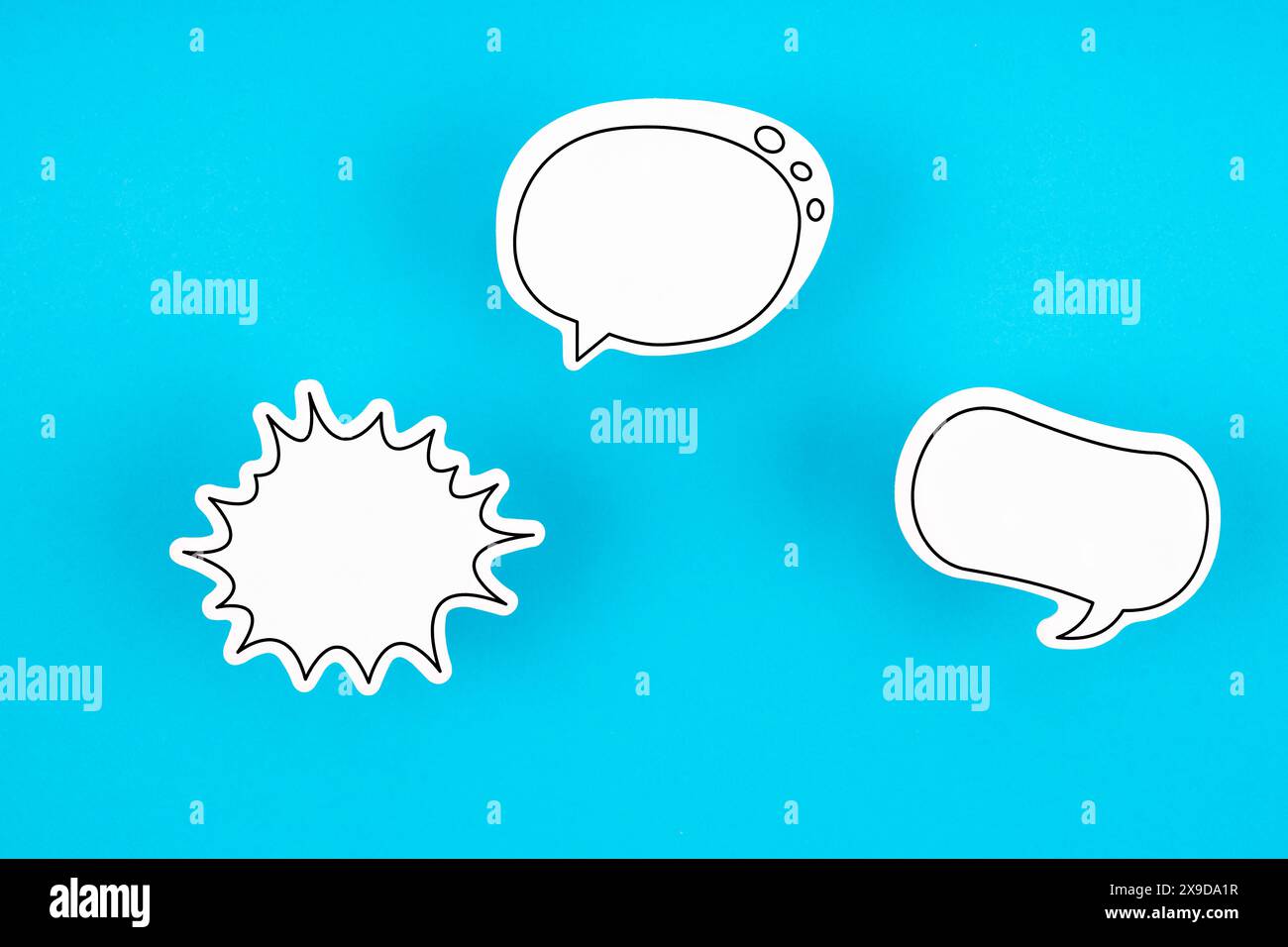 Empty white chat bubbles over blue background Stock Photo - Alamy