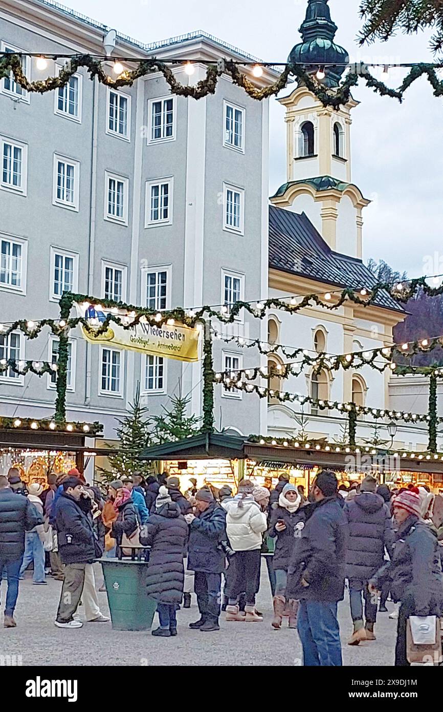 Salzburg, Austria - December 23, 2023: Christmas decorations and St. Michael church at Christmas Market in the Residenzplatz Stock Photo