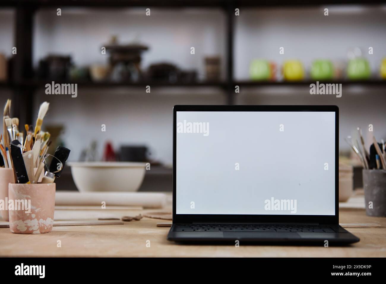 Background image of open laptop with blank white screen on wooden table ...