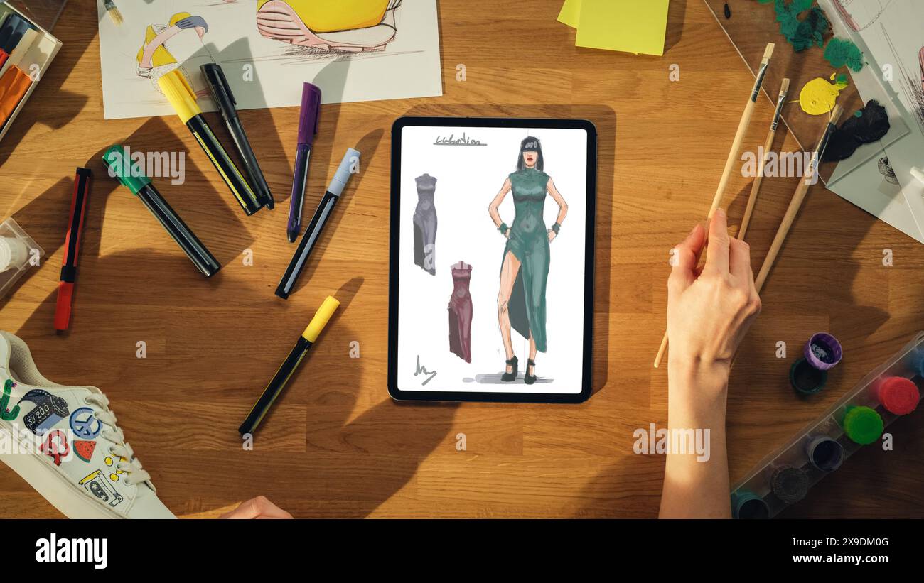 Top View Of Female Fashion Designer Drawing Sketch of Dress on Tablet ...