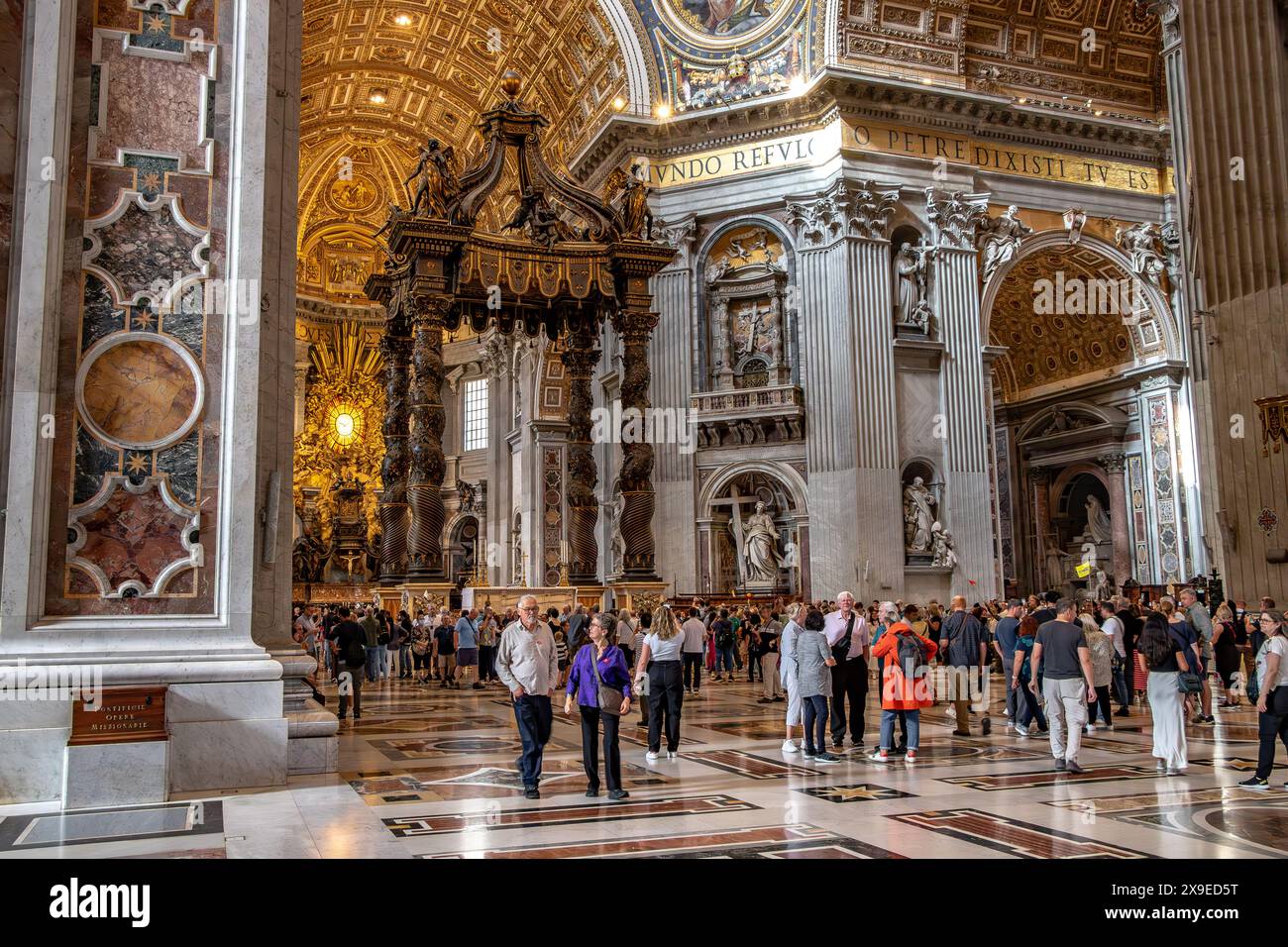 People walking through the central Nave inside St Peter's Bascillica ,Vatican City Stock Photo