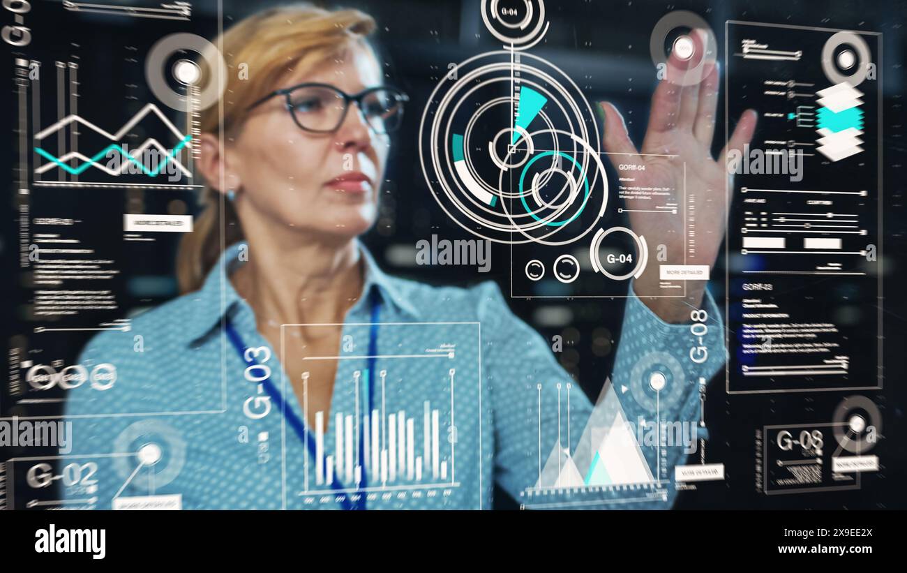 Adult Female Engineer Using Futuristic Augmented Reality Software Interface for Managing Data Center Work Projects. Specialist Researching Performance Data Graphs with Different Parameters. Stock Photo