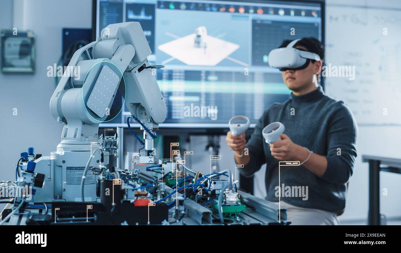 Computer Science Engineer in Virtual Reality Headset Using Controllers and Operating Robot Arm Under his Control. VFX Augmented Reality Icons Demonstrate Innovative Technologies Concept. Stock Photo
