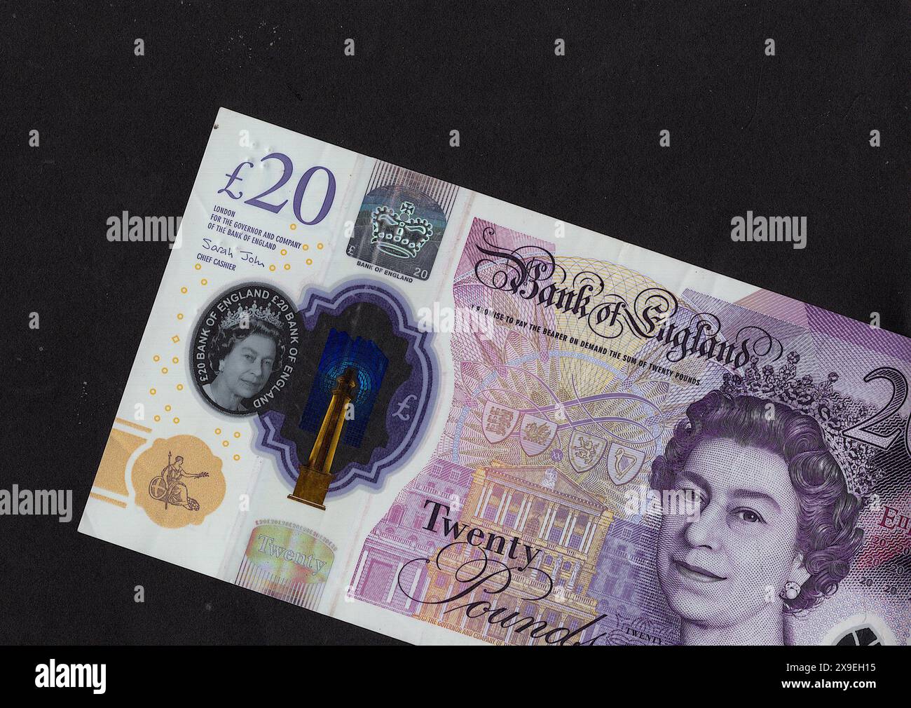 Close up of a modern twenty pound polymer banknote from the United Kingdom on a black background. Stock Photo