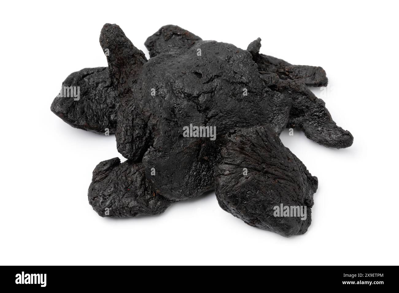 Heap of black Rehmannia glutinosa root close up isolated on white background Stock Photo