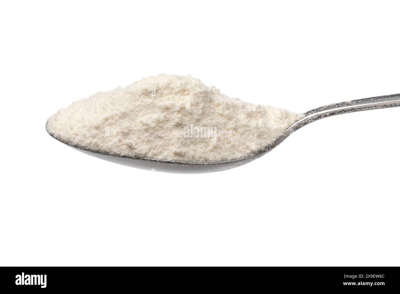 Metal spoon with wheat flour on white background close up Stock Photo