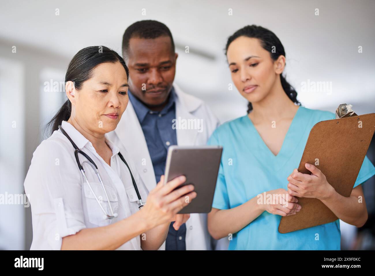 Multi-Ethnic Medical Team Collaborating in Hospital Setting Stock Photo ...