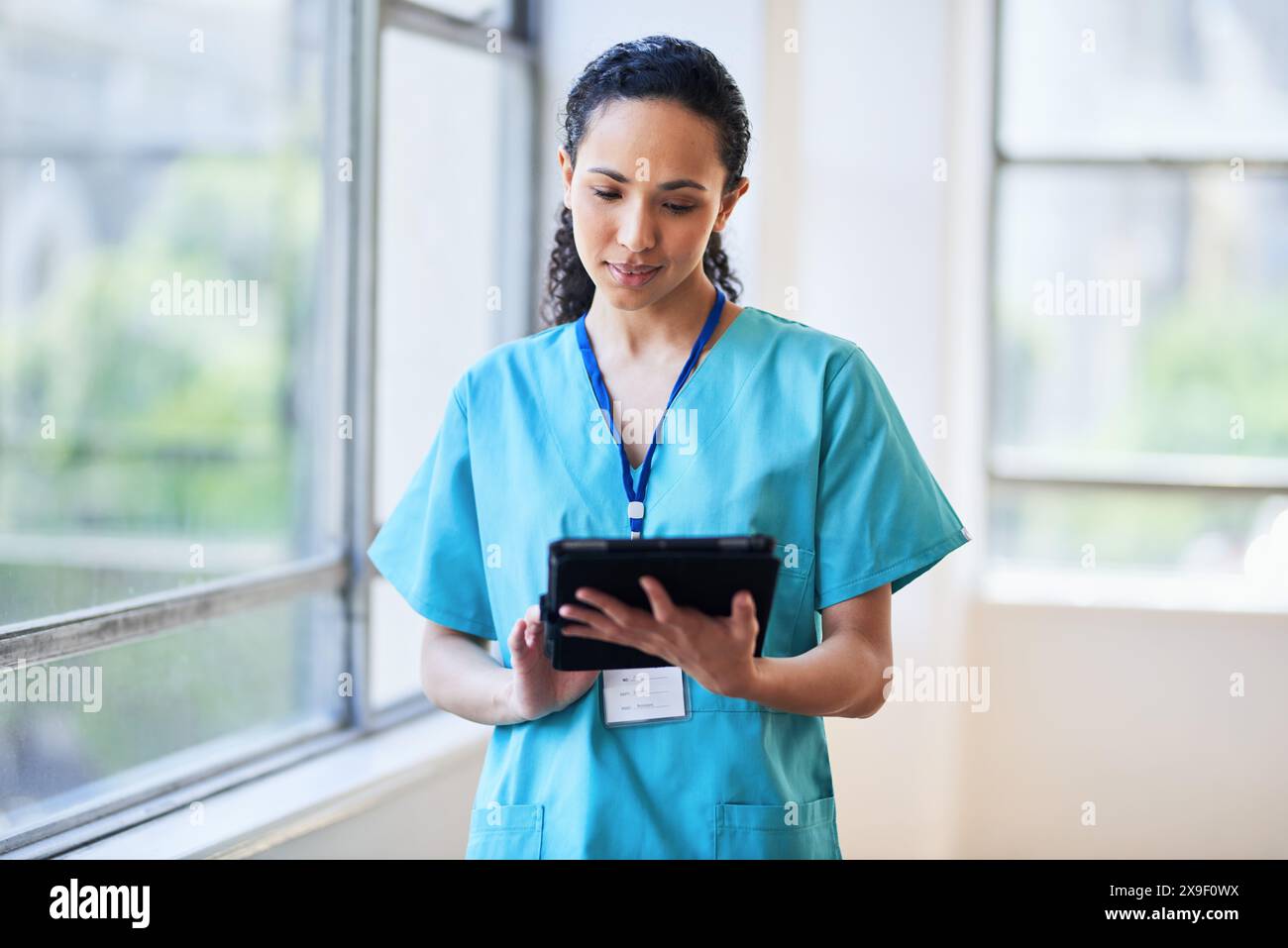 Medical Professional Using Digital Tablet in Hospital Setting Stock Photo