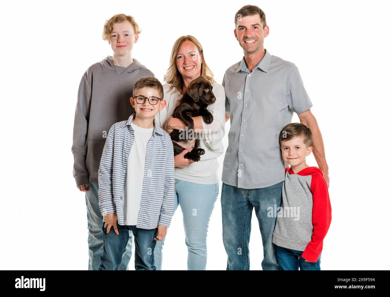 Family and the adorable young happy boys looking at camera Stock Photo ...