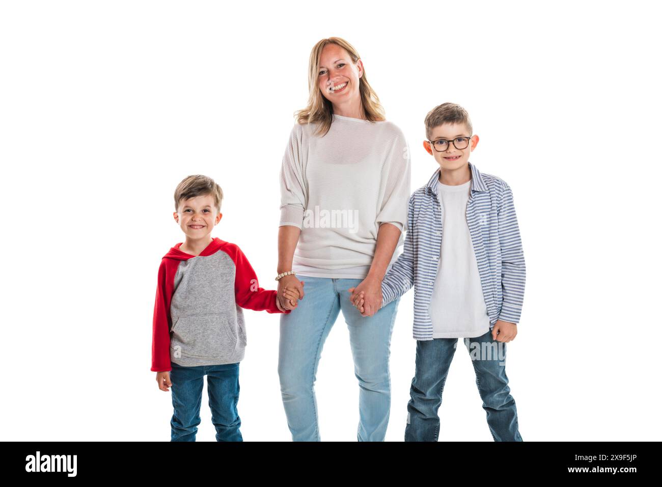 Photo of mother and the two adorable young happy boy looking at camera ...
