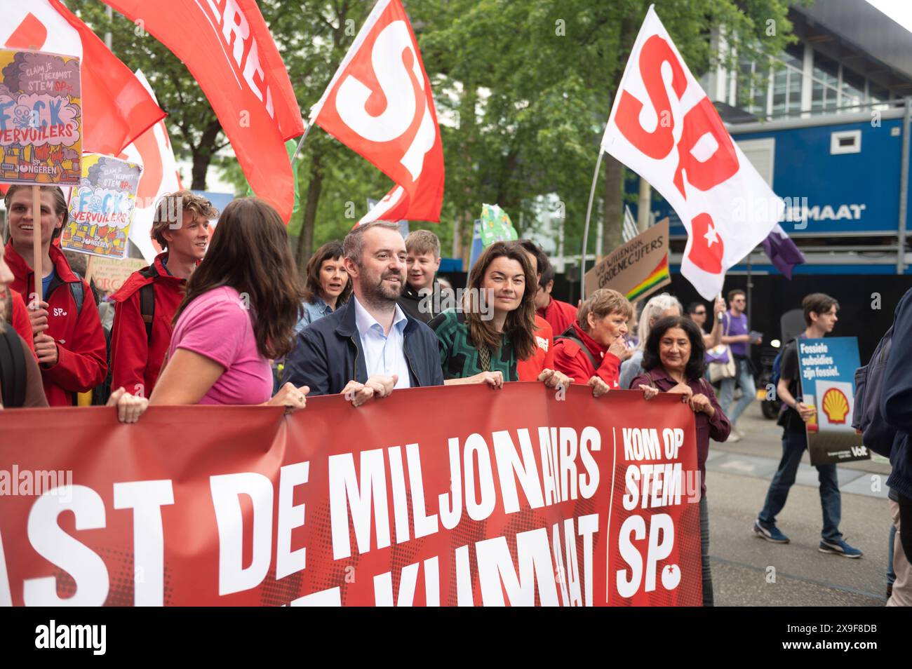 Amsterdam The Netherlands May 31st 2024 Klimaatmars. Climate March. In the Zuidas Amsterdam business district thousands march campaigning for a variety of environmental issues. Members of parliament for the SP, Sandra Beckerman, Jimmy Dijk and Sarah Dobbe with banner Belast de miljonairs niet de milieu, Tax the Millionaires not the environment. milieu, demo, demonstration, protest, mars, pvdd, Stock Photo