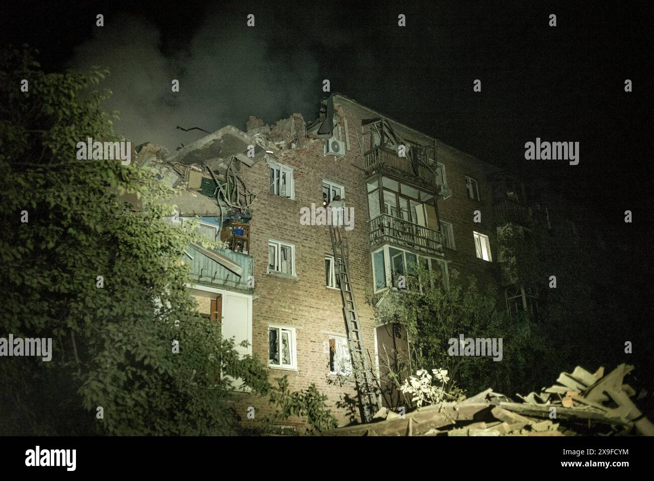 Nicolas Cleuet/Le Pictorium - UKR - Five S300 missiles attack the residential area of Novobavarsky - 30/05/2024 - Ukraine/kharkiv oblast/Kharkiv - Shortly before midnight, five S300 anti-aircraft missiles hit the residential area of Novobavarsky. The first two were fired less than five minutes apart, resulting in a double strike that affected the emergency services that arrived on the scene. One missile hit a five-storey building and destroyed three levels of one of the stairwells. Five people were killed and 25 injured, including two children aged 12 and 11. Stock Photo