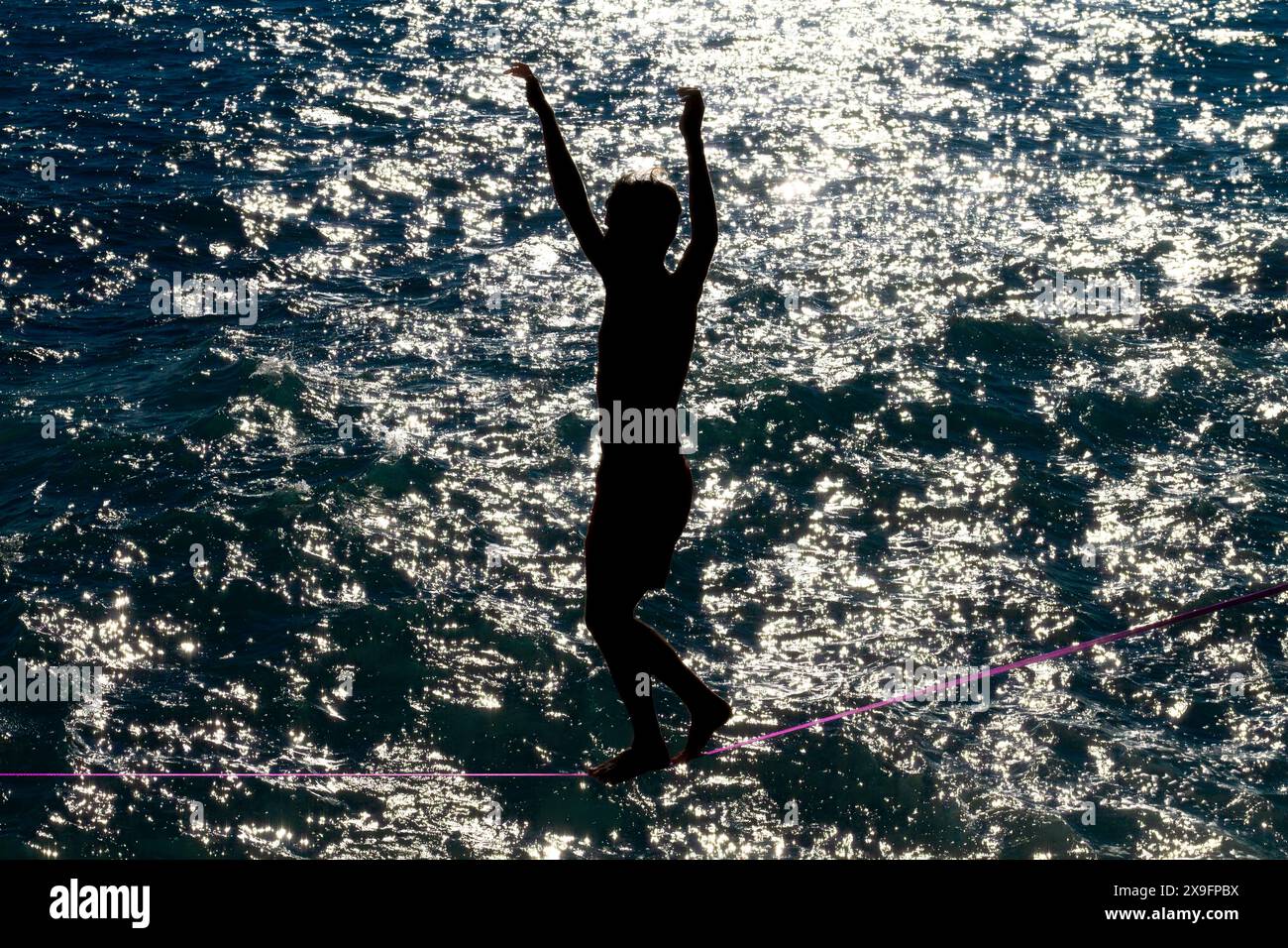 Slack-Line artist in dramatic scenery Stock Photo